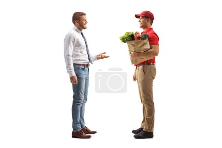 Man talking to a delivery man with a grocery bag isolated on white background