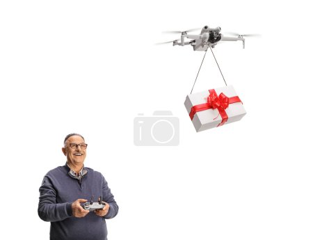 Photo for Happy mature man delivering a gift box with a drone isolated on white background - Royalty Free Image