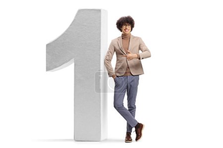 Photo for Full length portrait of a cheerful young man with glasses pointing at number one isolated on white background - Royalty Free Image