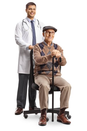 Doctor standing behind an elderly male patient seated in a chair isolated on white background