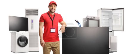 Photo for Appliance store manager with a flat tv screen and other electrical appliances isolated on white background - Royalty Free Image