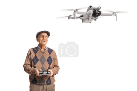 Photo for Senior man flying a drone with a remote controller isolated on white background - Royalty Free Image
