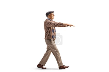 Photo for Full length profile shot of an elderly man sleepwalking isolated on white background - Royalty Free Image
