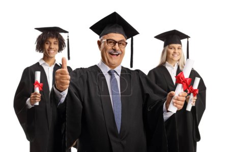 Photo for Graduation students and a mature man holding certificates and gesturing thumbs up isolated on white background - Royalty Free Image