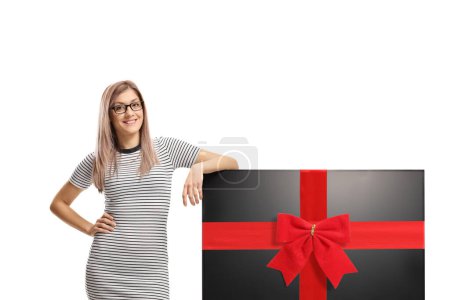 Photo for Young woman with a tv tied with a red ribbon isolated on white background - Royalty Free Image