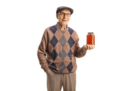 Elderly man holding a jar of honey and smiling isolated on white background