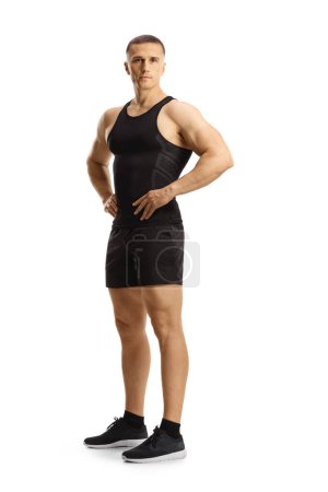 Photo for Full length portrait of a man in sports black top and shorts isolated on white background - Royalty Free Image