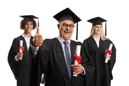 Graduation students and a mature man holding diplomas and gesturing thumbs up isolated on white background