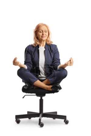 Photo for Woman sitting in an office chair and practicing meditation isolated on white background - Royalty Free Image