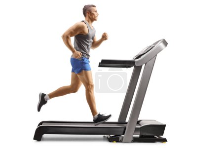 Photo for Fit young man running on a treadmill isolated on white background - Royalty Free Image