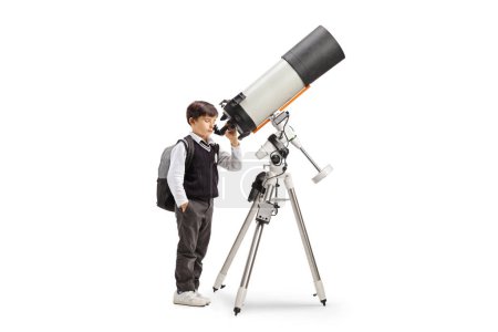Photo for Schoolboy observing the planets and stars with a telescope isolated on white background - Royalty Free Image