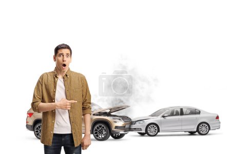 Photo for Shocked young man pointing at car collision isolated on white background - Royalty Free Image