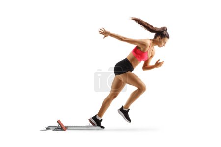 Photo for Full length profile shot of a female runner on a starting block isolated on white background - Royalty Free Image