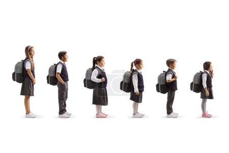 Photo for Full length profile shot of schoolchildren waiting in line isolated on white background - Royalty Free Image