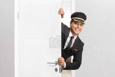 Photo for Chauffeur standing behind a white door - Royalty Free Image