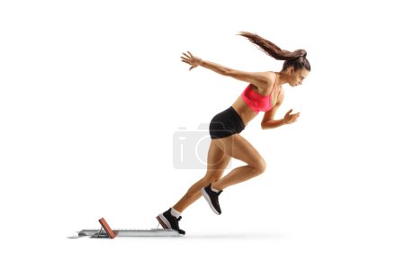 Photo for Female runner starting a race from a starting block isolated on white background - Royalty Free Image
