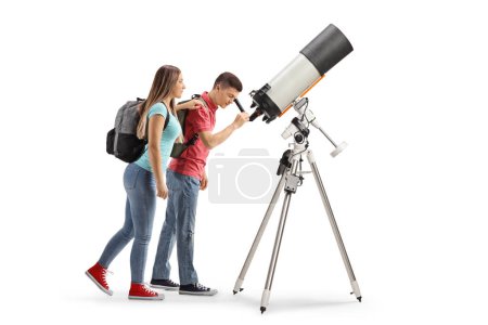 Photo for Teenage girl and boy students looking through a telescope isolated on white background - Royalty Free Image