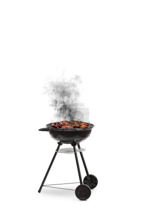 Burnt grilled meat on a barbecue with smoke isolated on white background