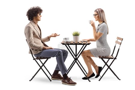 Photo for Young man and woman having coffee and talking isolated on white background - Royalty Free Image