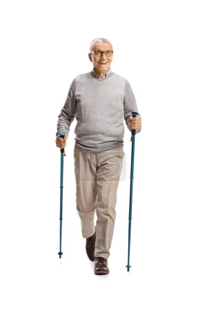 Photo for Elderly man walking with poles towards the camera isolated on white background - Royalty Free Image