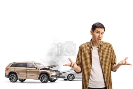 Photo for Confused young man and a car crash isolated on white background - Royalty Free Image