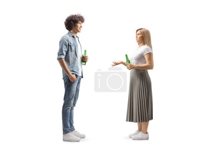 Photo for Full length profile shot of a young man and woman holding bottles of beer and talking isolated on white background - Royalty Free Image