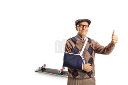 Elderly man with a broken arm injured from a skateboard fall gesturing thumbs up isolated on white background