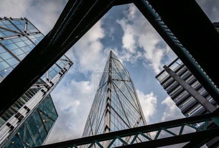 Photo for London, UK: The Broadgate Tower on Bishopsgate in the City of London. View from  Worship Street below the steel girders of the railway bridge. - Royalty Free Image