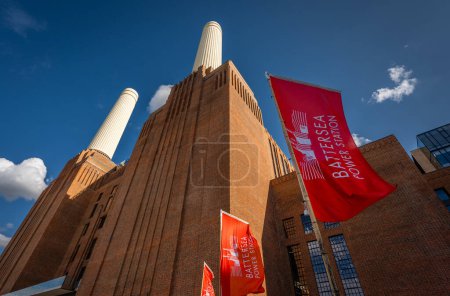 Photo for Battersea, London, UK: Battersea Power Station now redeveloped as a shopping and leisure destination. Landscape view of the north side of the building with red flags. - Royalty Free Image