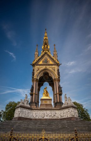 Photo for London, UK: The Albert Memorial in Kensington Gardens in memory of Prince Albert, the husband of Queen Victoria. West view with decorative railings in foreground. - Royalty Free Image