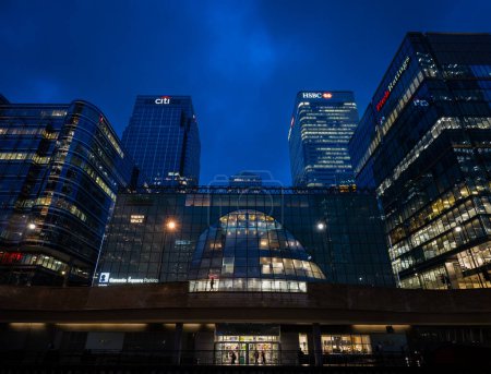 Photo for Canary Wharf, London, UK: View of Canary Wharf in the evening seen from Churchill Place Shopping Mall looking towards Canada Square. Tall buildings and skyscrapers with lights at night. - Royalty Free Image