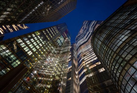 Photo for London, UK: Tall buildings in the City of London seen from Undershaft at night. Including (L-R): St Helen's, the Scalpel, the Cheesegrater, 8 Bishopsgate and 22 Bishopsgate. - Royalty Free Image