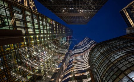 Photo for London, UK: Tall buildings in the City of London seen from Undershaft at night. Including (L-R): The Cheesegrater, 8 Bishopsgate and 22 Bishopsgate with St Helen's (top). - Royalty Free Image