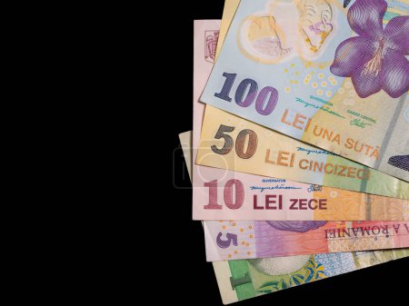 Many romanian banknotes on black background. Romanian currency concept.