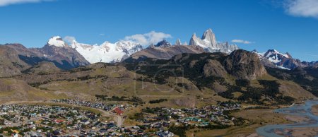 El Chalten village with panorama of mountain range Fitz Roy on a sunny day with blue sky. It is a mountain in Patagonia, on the border between Argentina and Chile.