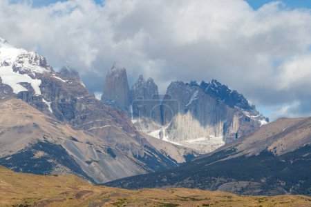 Granite peaks torres seen at a distance on a cloudy day, national park Torres del Paine, Patagonia, Chile, South America