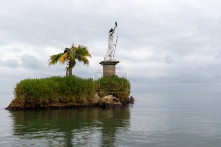 Statue god of the ocean in the middle of the ocean in livingstone guatemala.