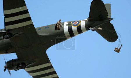 Photo for Victory Show. Leicester, UK, September. World war two living history show and airshow. The Douglas C-47 Skytrain or Dakota is a military transport aircraft developed from the civilian Douglas DC-3 airliner. Parachute troops dropping. - Royalty Free Image