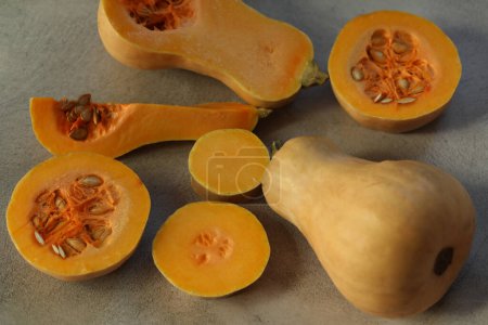 Photo for Cut fresh pumpkin on the grey background - Royalty Free Image