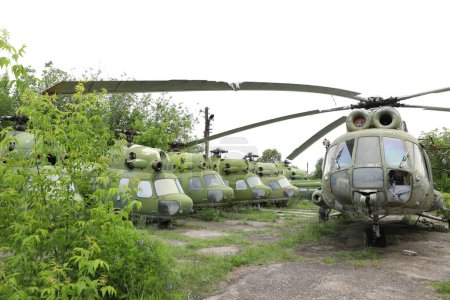 Photo for Abandoned damaged russian military helicopter Mil Mi-2 Hoplite and Mil Mi-2 Hip. broken air copter - Royalty Free Image