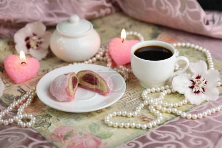 Photo for Colorful japanese sweets daifuku or mochi sliced. Sweets close up on the plate with cup of coffee and candles - Royalty Free Image