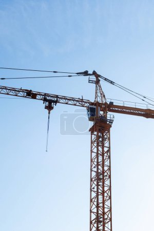Photo for Huge crane tower against a blue sky. Construction background - Royalty Free Image