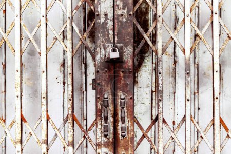 Photo for Rusty master key locked. Padlock on fence. Metal door with lock - Royalty Free Image