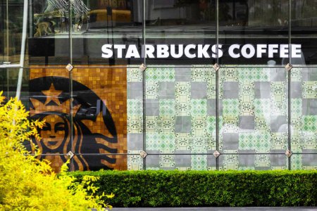 Photo for Bangkok, Thailand - March 8, 2024 : Starbucks coffee shop in downtown. Company signboard Starbucks Coffee - Royalty Free Image