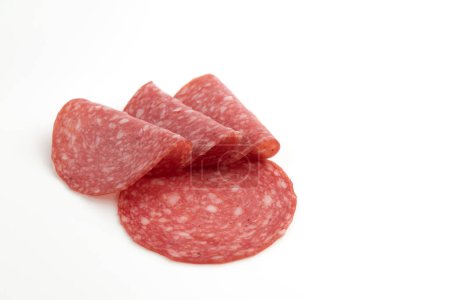 Photo for Salami sausage slices isolated on white background, pieces of sliced salami sausage laid out to create layout - Royalty Free Image