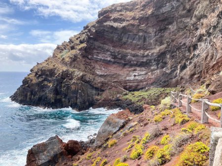 Photo for A young woman walking towards the Nogales beach, La Palma Island, Canary Islands, Spain. - Royalty Free Image