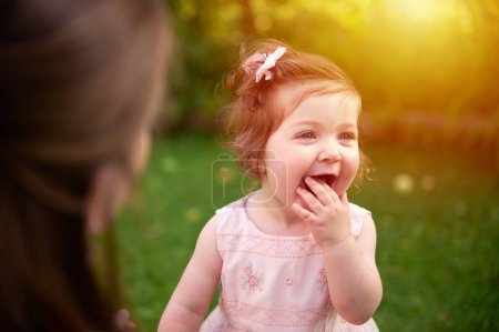 Photo for Mommy and her doughter playing in the garden. Lovely family posing outdoors. Happy little girl in summer scenery. Sweet small kid outdoors. - Royalty Free Image
