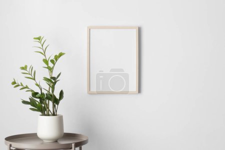 Photo for Wooden frame mockup on the wall with a zamia flower decoration. - Royalty Free Image