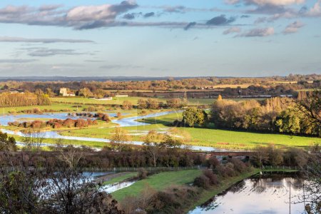Photo for Looking out towards Hamsey church from near Lewes, with the fields flooded following recent heavy rainfall - Royalty Free Image