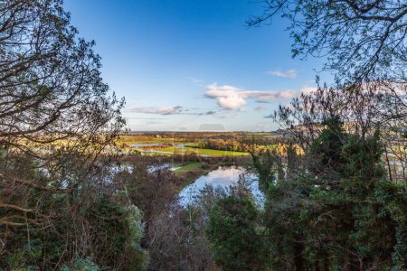 Photo for Flooded fields from the River Ouse in Sussex, on a sunny November day - Royalty Free Image
